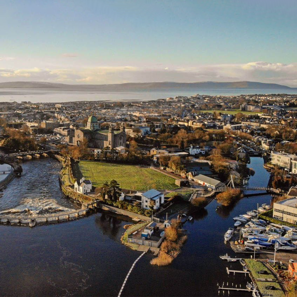 An aerial view of a city of Galway Ireland with a river in the background.