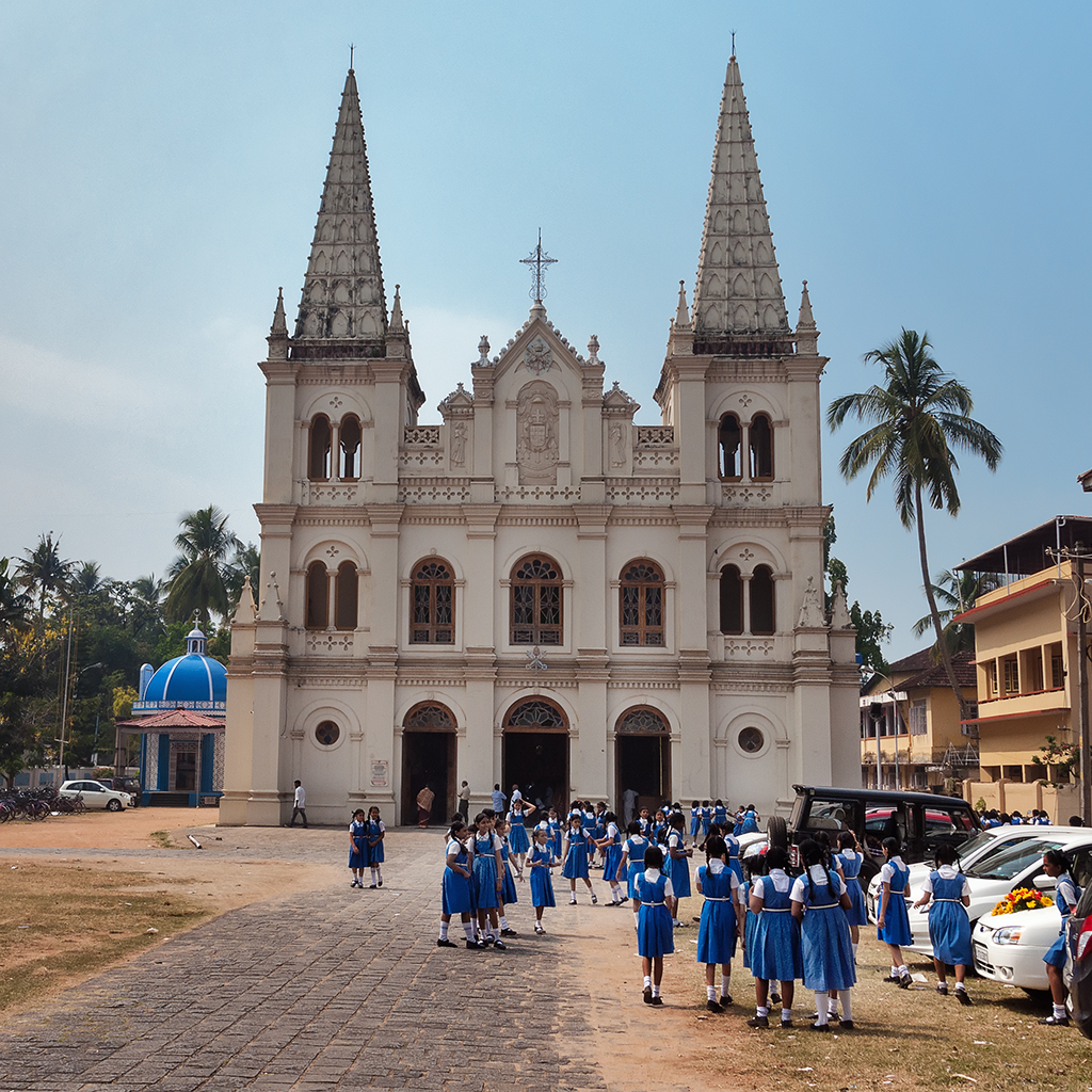 A group of young school girls in school uniforms in front of the Santa Cruz basilica Kochi India